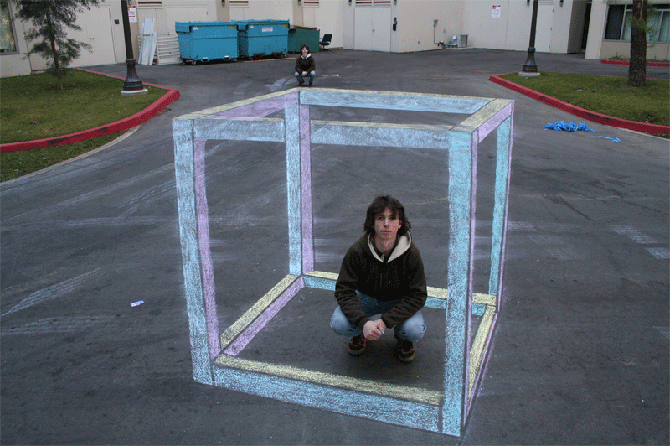 Anamorphic chalk cube drawing on pavement